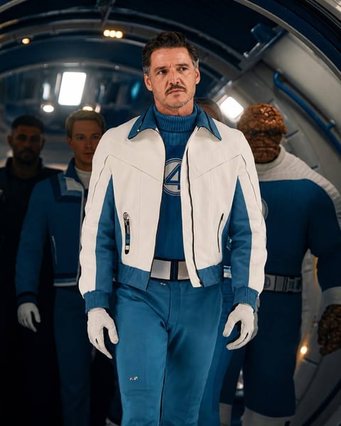 Man in white and blue futuristic uniform standing in spaceship with crew members in background
